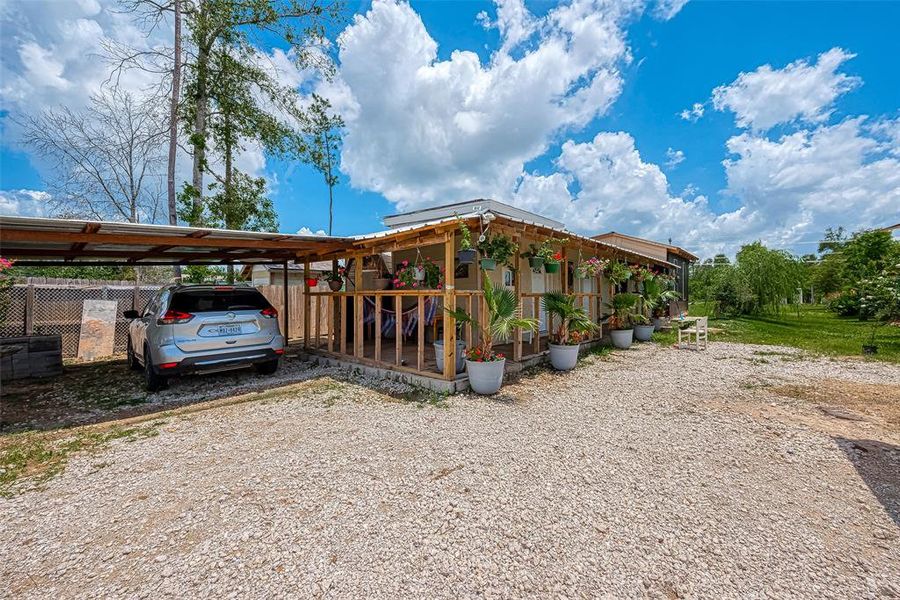 An attached carport within the gate provides convenient and secure parking right on the property, ensuring ease of access and added security.