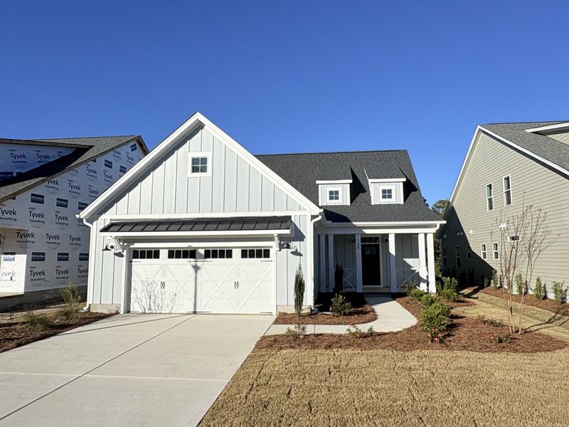 Front exterior of a new home in Riverside Cove, Wilmington, NC, highlighting curb appeal (Image 2).