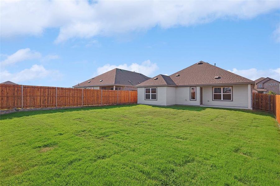 Rear view of property featuring a yard