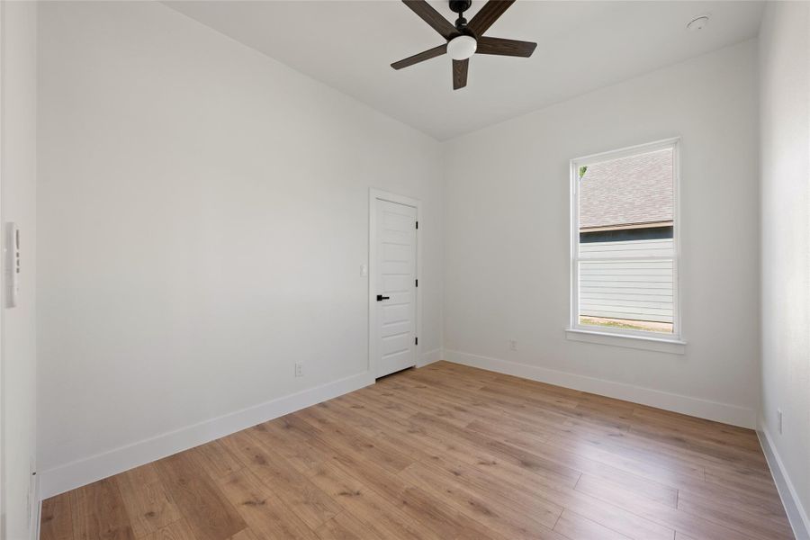 Unfurnished room featuring light wood-style floors and ceiling fan
