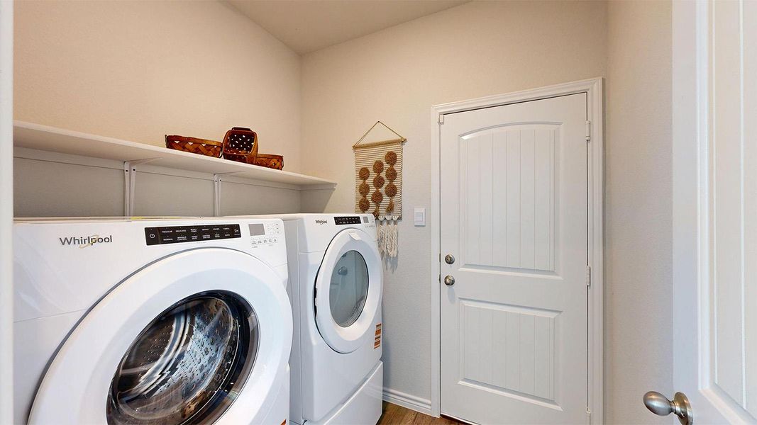 Laundry area with separate washer and dryer and light wood-style floors Laundry area with separate washer and dryer and light wood-style floors