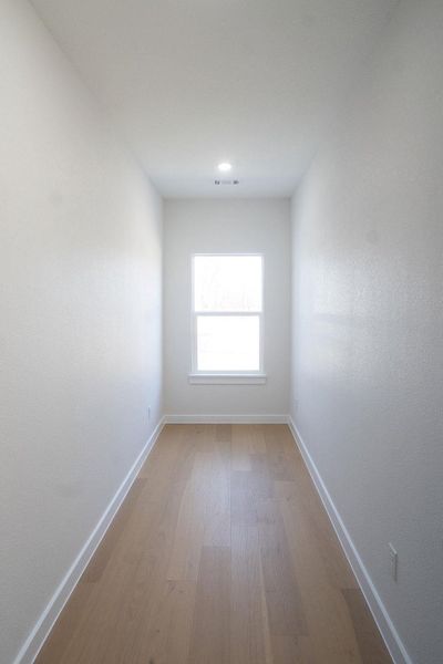 Empty room featuring light wood-style floors and recessed lighting