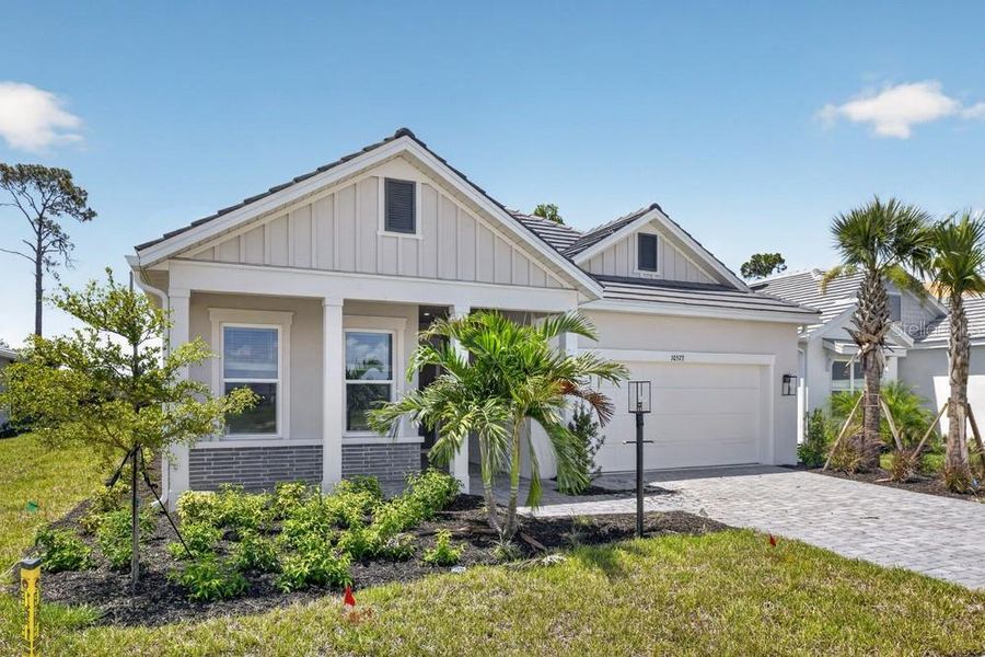 Front exterior of a new home in Skye Ranch Community Group Page, Sarasota, FL, highlighting curb appeal (Image 13).