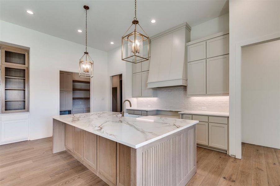 View of kitchen featuring quartz countertops and champagne bronze fixtures. View of kitchen featuring quartz countertops and champagne bronze fixtures.