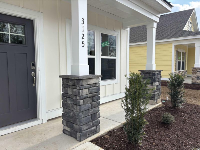 View of exterior entry with a porch