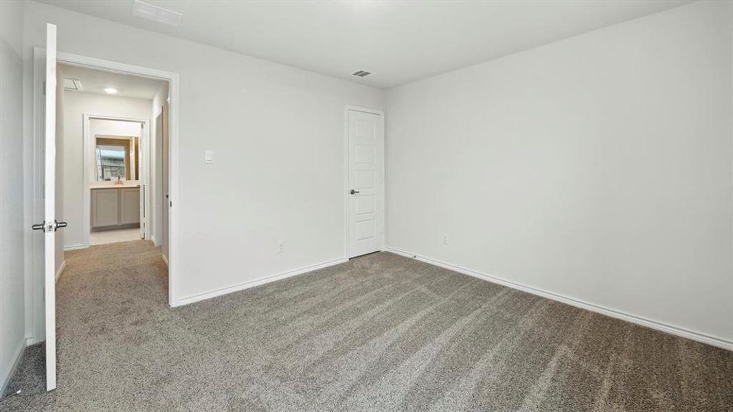 Empty room with carpet floors and baseboards