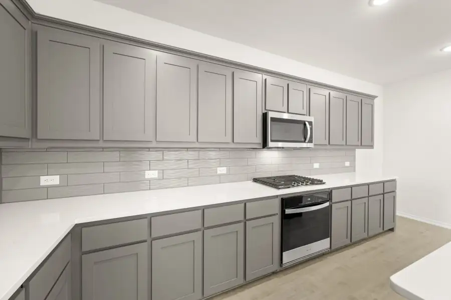 Front exterior of a new home in Myrtle Creek, Waxahachie, TX, highlighting curb appeal (Image 10). Front exterior of a new home in Myrtle Creek, Waxahachie, TX, highlighting curb appeal (Image 10).