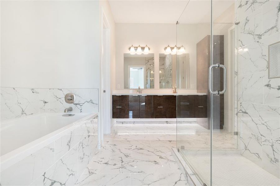 The master bathroom features a freestanding tub and separate shower with a double vanity. Tile and cabinetry can be customized if purchased before construction is complete!