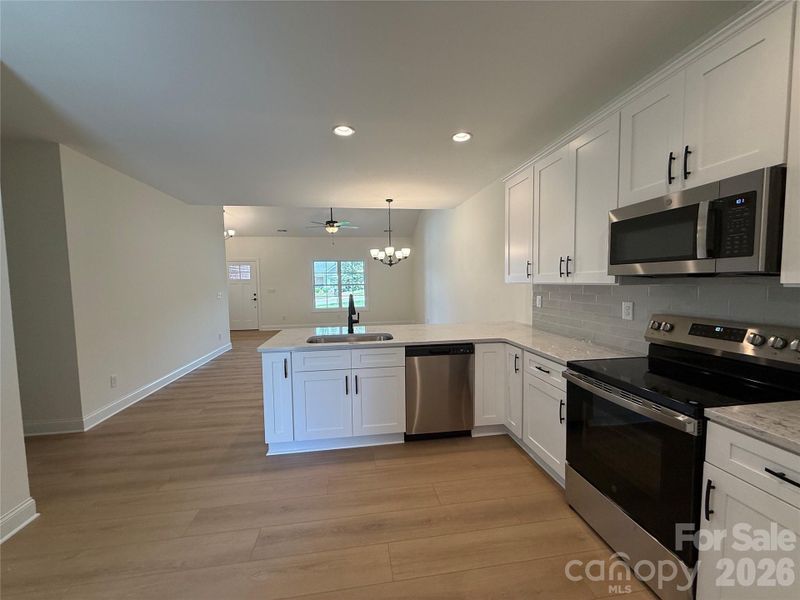 ...custom backsplash, and stainless steel appliances.