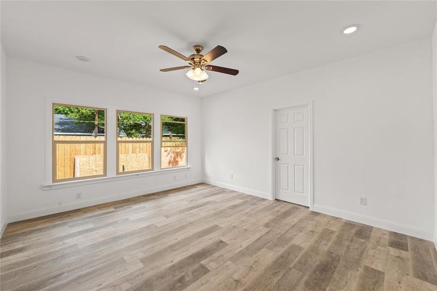 Spare room with ceiling fan and light hardwood / wood-style flooring