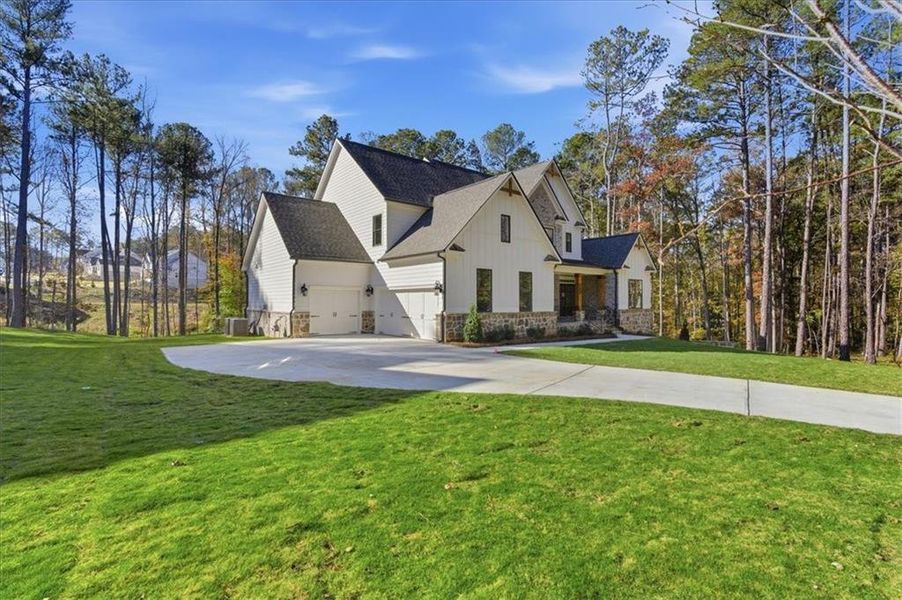 Front exterior of a new home in Ford Landing, Acworth, GA, highlighting curb appeal (Image 24). Front exterior of a new home in Ford Landing, Acworth, GA, highlighting curb appeal (Image 24).