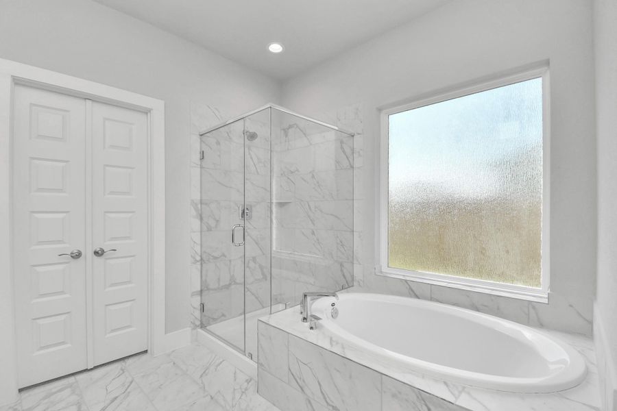 Indulge in a spa-like retreat within the confines of this primary bathroom. Delight in a spacious walk-in shower enveloped in stylish tile surround, unwind in a separate garden tub adorned with custom detailing. Sample photo of completed home with similar floor plan. Actual colors and selections may vary.