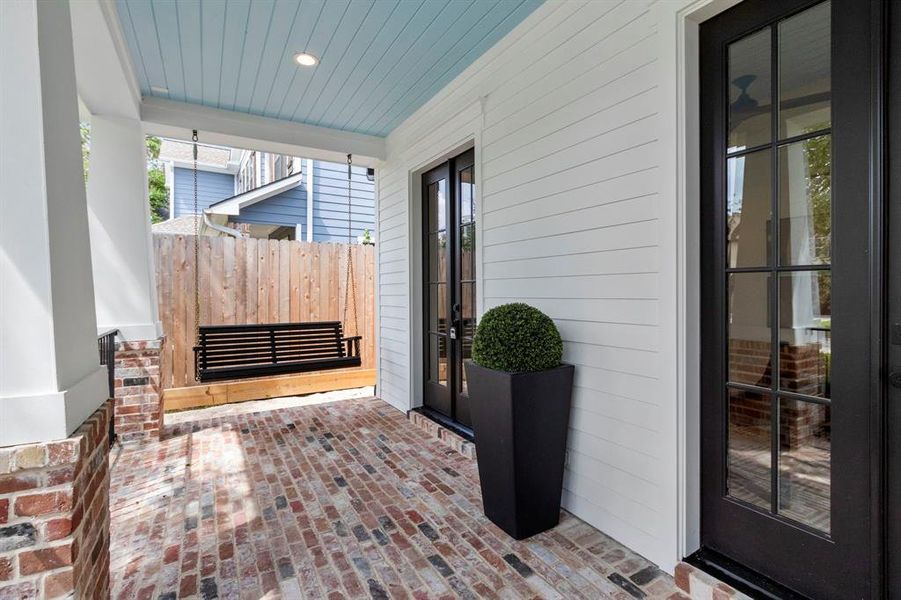 Full Brick Front Porch offers two sets of French doors leading to the study & a Porch Swing