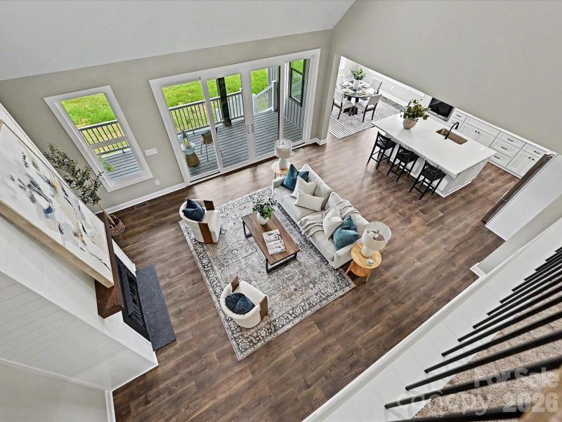 Open-to-below design showcases the expansive great room, flowing layout, and stunning views of the covered outdoor living space.