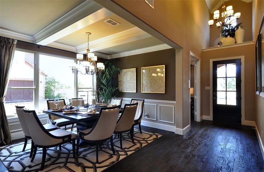 Formal dining room with large windows off foyer of home Formal dining room with large windows off foyer of home