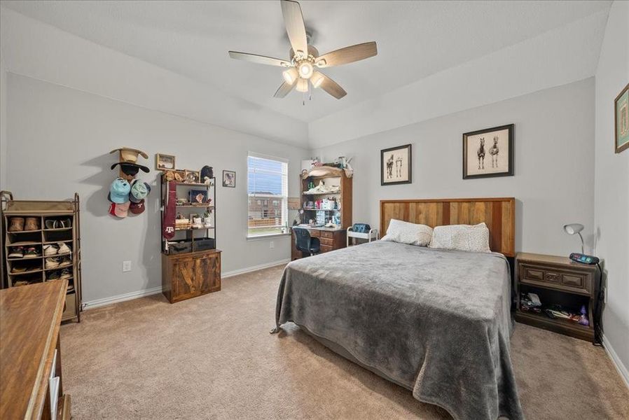 Bedroom 3 with closet, light carpet and ceiling fan.