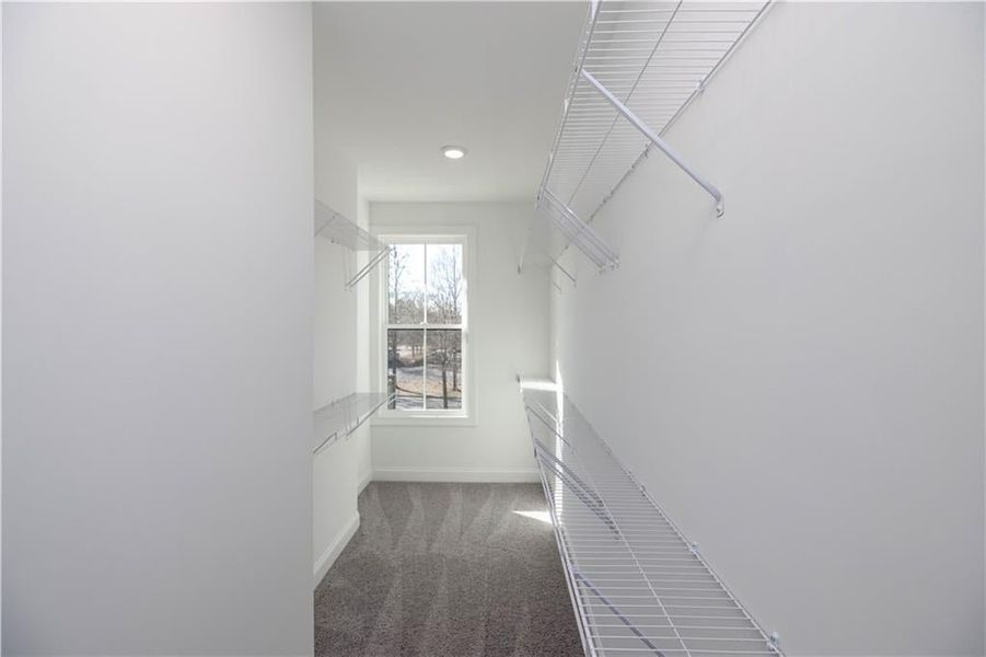 The primary closet gives you tons of room for your clothes and accessories.