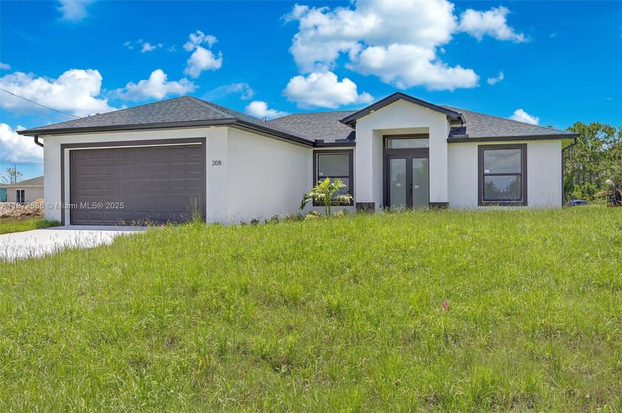 Front exterior of a new home in , Lehigh Acres, FL, highlighting curb appeal (Image 2).