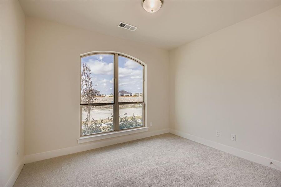 Spare room with light carpet and baseboards Spare room with light carpet and baseboards