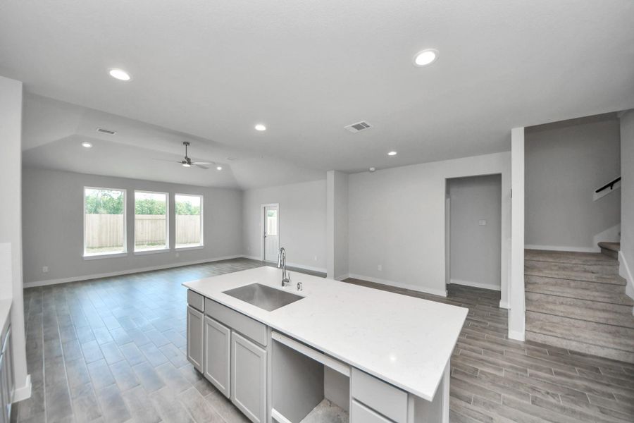 All of this overlooks your expansive family room, creating a perfect space for culinary delights and family gatherings. Sample photo of completed home with similar floor plan. Actual colors and selections may vary.