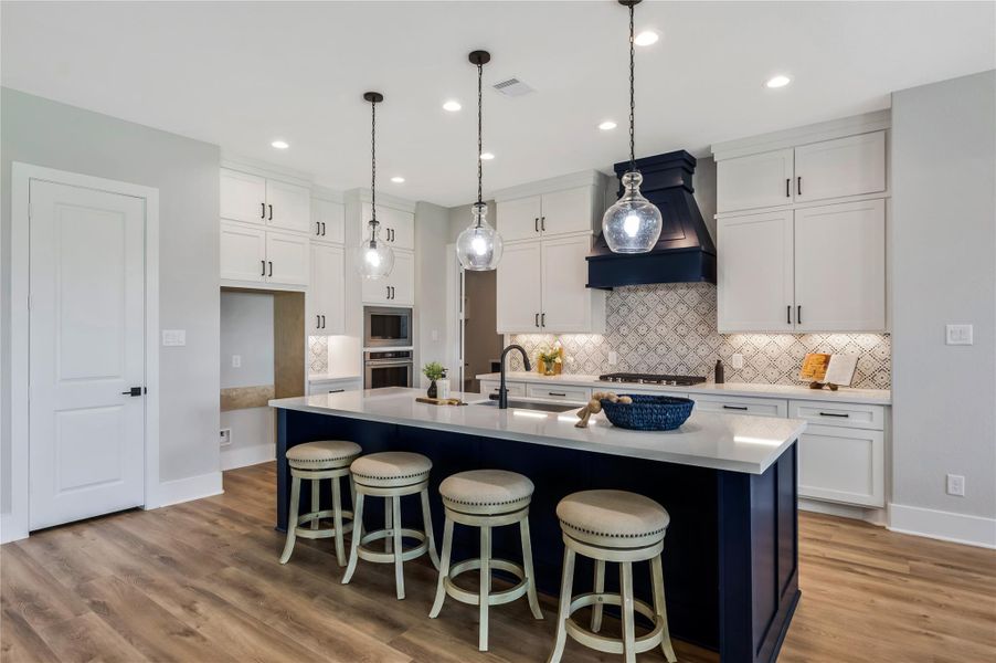 Decorative backsplash and pendant lights really bring this space together Decorative backsplash and pendant lights really bring this space together