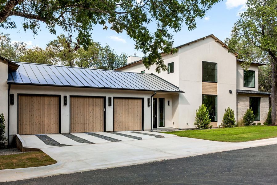 Smooth stucco and warm wood details define this contemporary multi-level exterior facade.