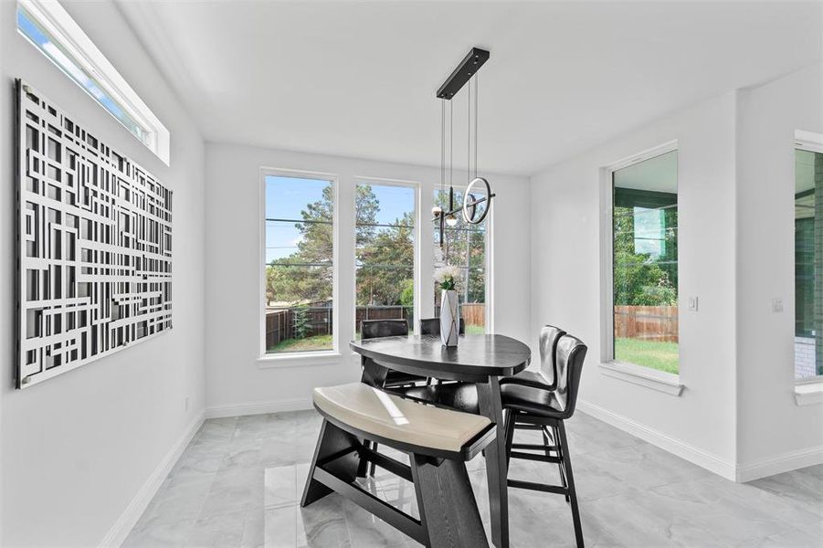 Dining room featuring a chandelier and a healthy amount of sunlight