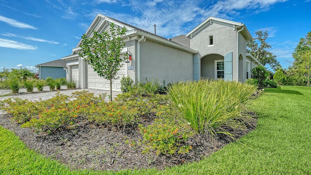 Front exterior of a new home in Wildleaf Real Estate and Homes for Sale in Parrish, FL - Neal Communities, Parrish, FL, highlighting curb appeal (Image 20).