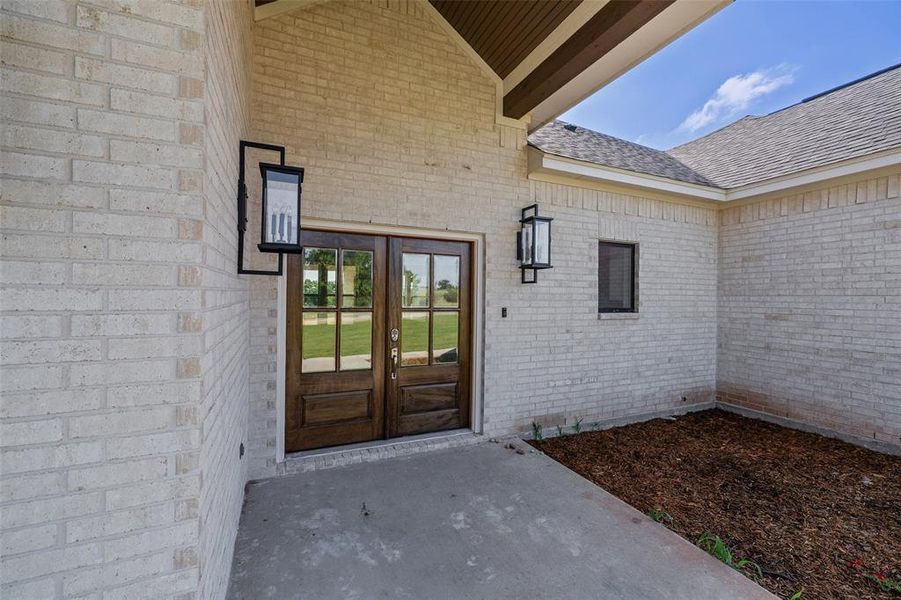 Double entry doors with divided lites and dark wood finish
