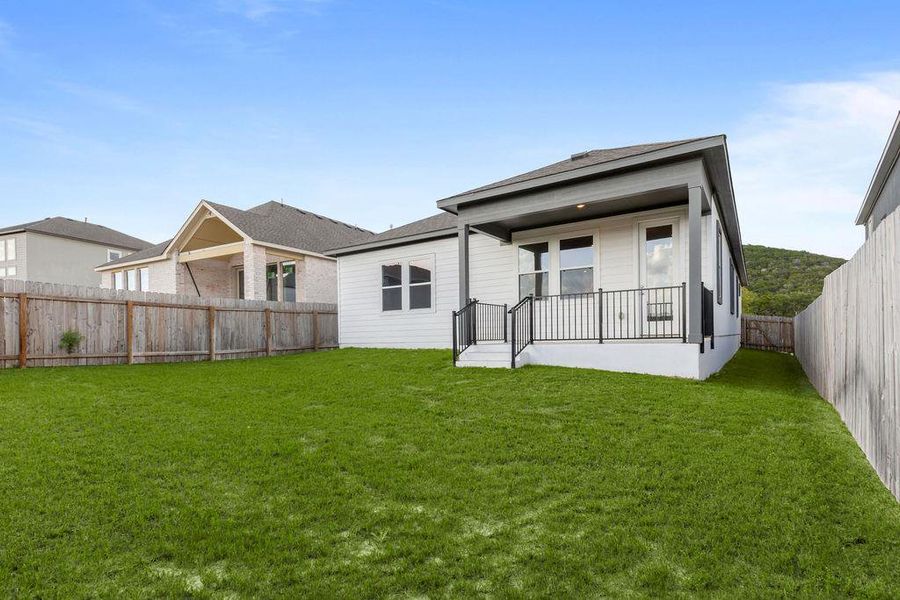A verdant lawn wraps around a contemporary dwelling with a covered patio, perfect for outdoor enjoyment. A verdant lawn wraps around a contemporary dwelling with a covered patio, perfect for outdoor enjoyment.