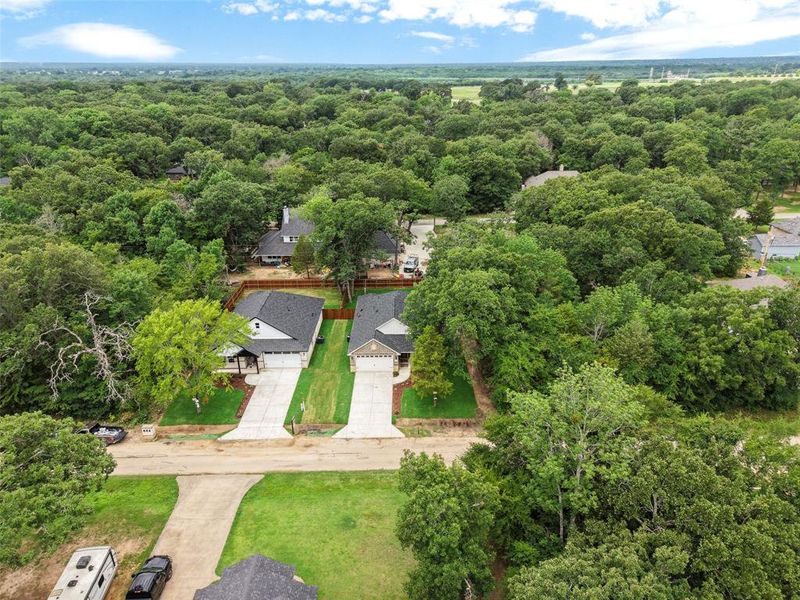 New construction residences featuring dark shingle roofing, light-toned siding, and attached garages New construction residences featuring dark shingle roofing, light-toned siding, and attached garages
