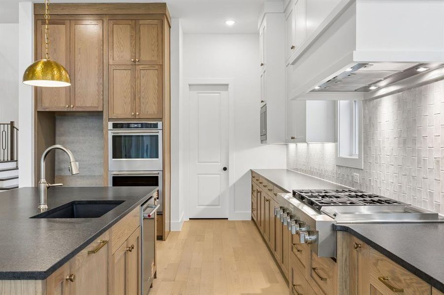 Beautiful two tone cabinetry, gorgeous counter tops and stylish backsplash effortlessly pair with contemporary, top of the line stainless steel appliances to create a dream kitchen for the ages!