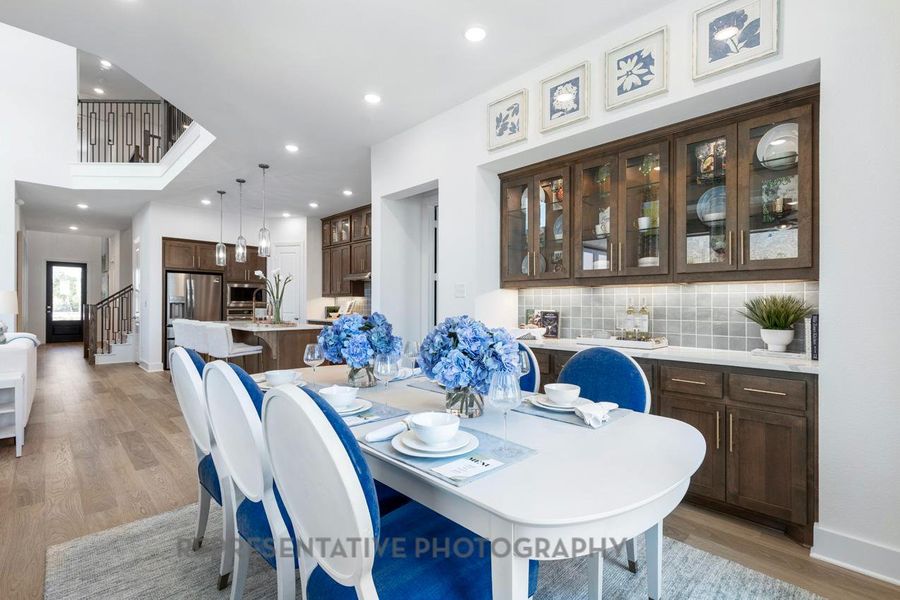 Dining space featuring light wood finished floors, recessed lighting, and stairway