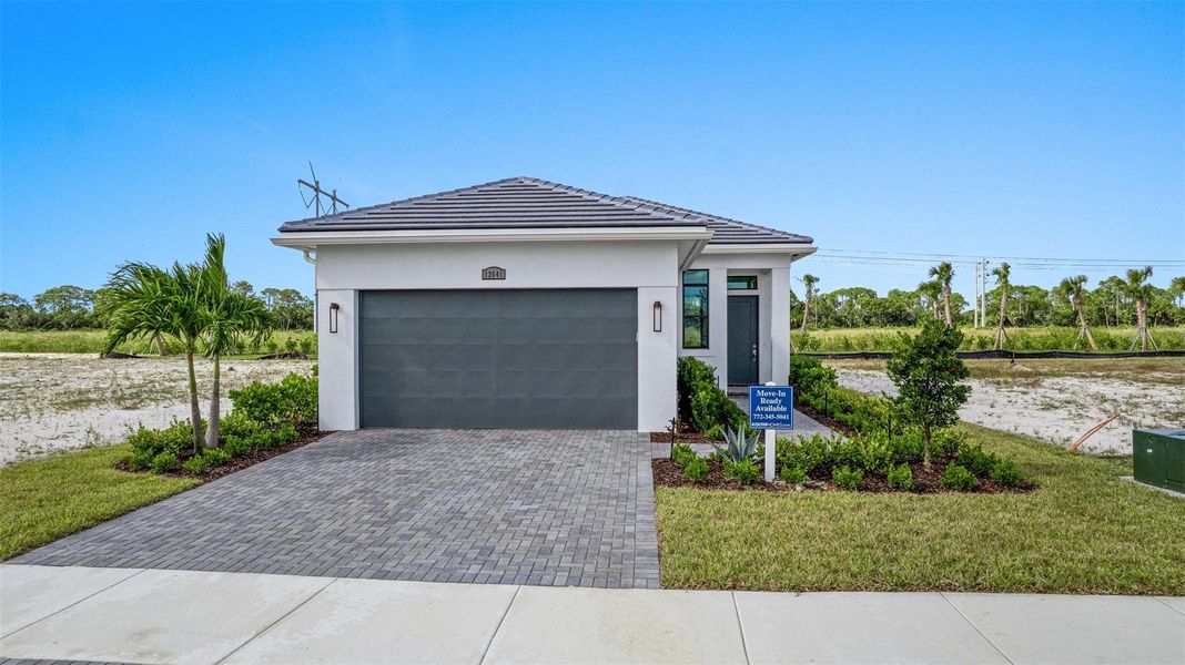 Front exterior of a new home in PGA Village Verano, Port St. Lucie, FL, highlighting curb appeal (Image 20). Front exterior of a new home in PGA Village Verano, Port St. Lucie, FL, highlighting curb appeal (Image 20).