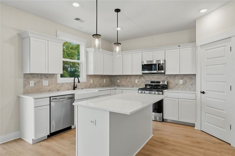Crisp white cabinetry paired with sleek stone coun