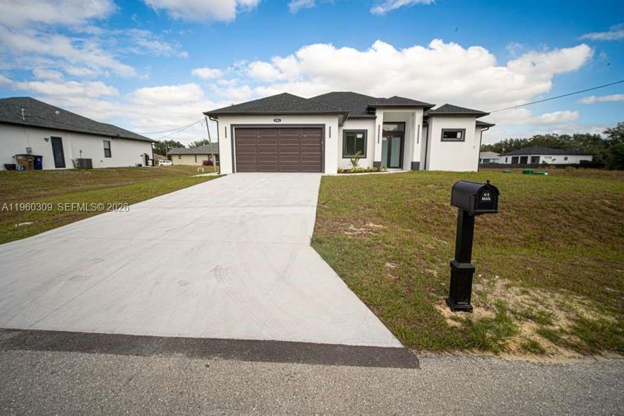 Front exterior of a new home in , Lehigh Acres, FL, highlighting curb appeal (Image 19).