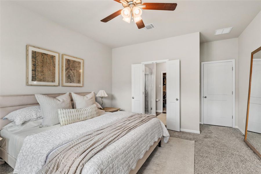A tranquil bedroom retreat features soft gray carpeting and a dual-purpose ceiling fan for comfort and illumination. A tranquil bedroom retreat features soft gray carpeting and a dual-purpose ceiling fan for comfort and illumination.