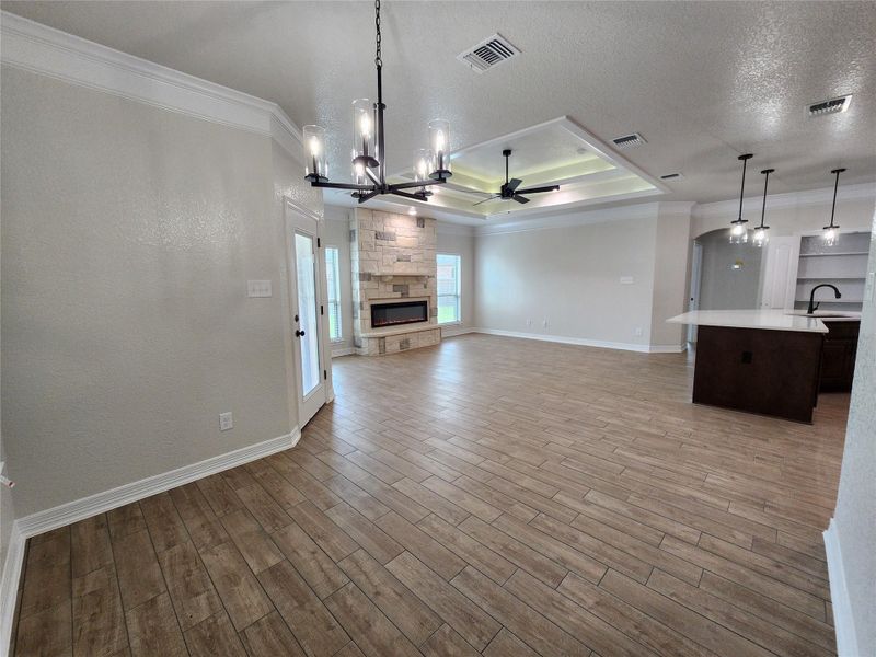 An open-concept living space with a contemporary fireplace and a streamlined kitchen island awaits. An open-concept living space with a contemporary fireplace and a streamlined kitchen island awaits.