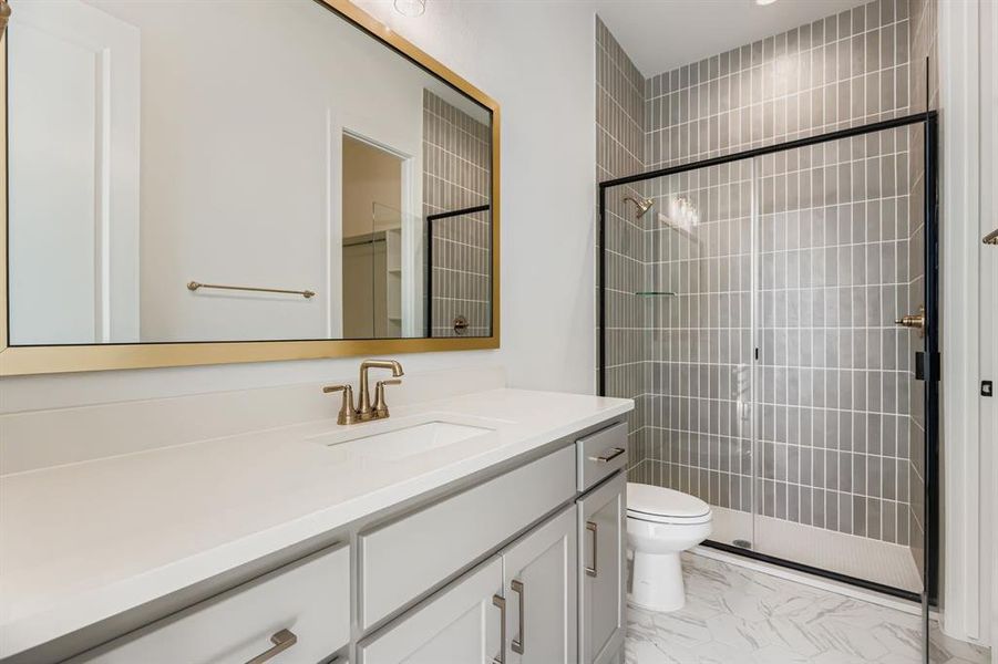 Full bathroom featuring vanity, a shower stall, and light marble finish flooring