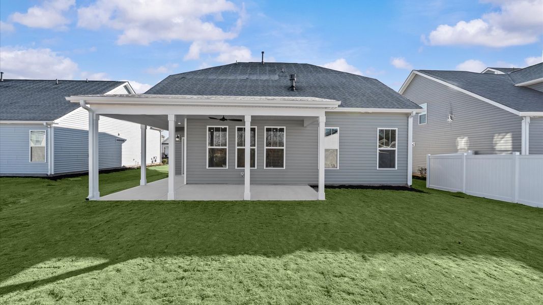 Exceptional outdoor living begins with a covered back porch in this thoughtfully designed home