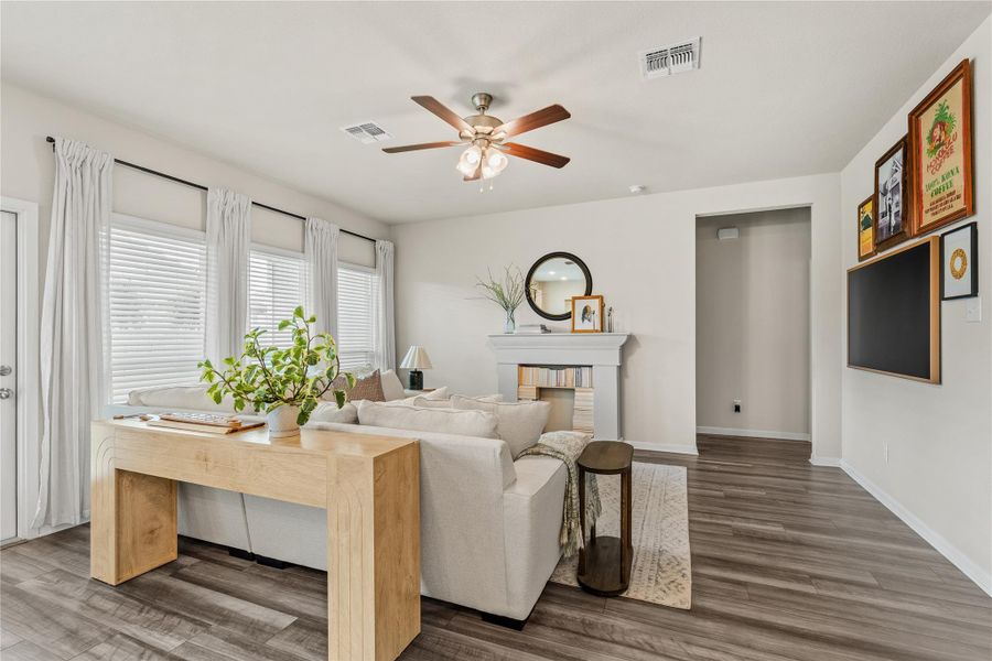 A comforting living area features warm wood flooring and a classic fireplace mantel. A comforting living area features warm wood flooring and a classic fireplace mantel.