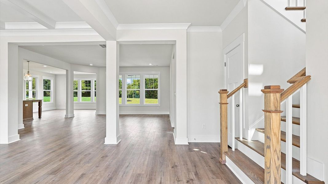 Exceptional foyer with warm hardwood flooring and refined finishes throughout