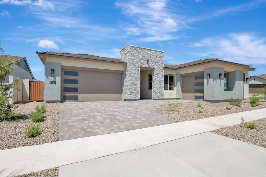 Front exterior of a new home in Blossom Rock, Apache Junction, AZ, highlighting curb appeal (Image 2). Front exterior of a new home in Blossom Rock, Apache Junction, AZ, highlighting curb appeal (Image 2).