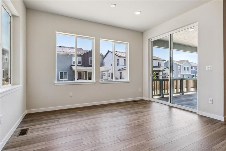 A room with a wood floor and windows.