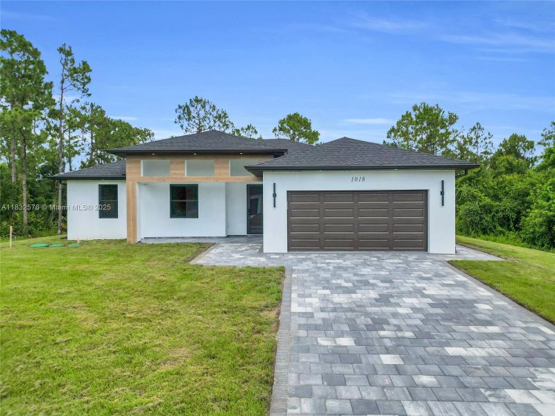 Front exterior of a new home in , Lehigh Acres, FL, highlighting curb appeal (Image 28).
