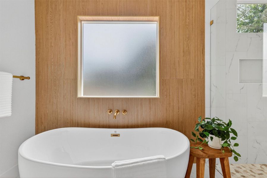 Full bath with a freestanding tub and a walk in shower