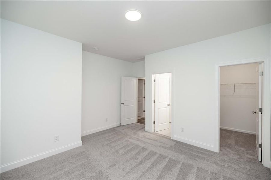 Secondary bedroom with walk in closet. Pictures represent a previously built home not the actual home, home is under construction.