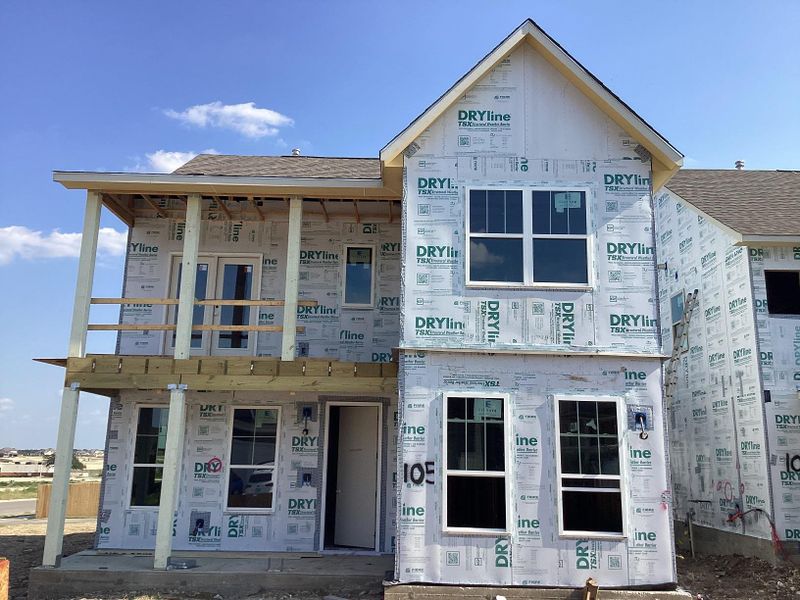 Front exterior of a new home in The Cottages at Lariat, Liberty Hill, TX, highlighting curb appeal (Image 1). Front exterior of a new home in The Cottages at Lariat, Liberty Hill, TX, highlighting curb appeal (Image 1).