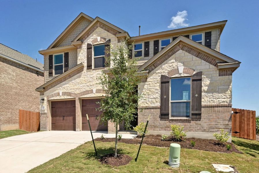 Front exterior of a new home in Salerno - Classic Collection, Round Rock, TX, highlighting curb appeal (Image 2). Front exterior of a new home in Salerno - Classic Collection, Round Rock, TX, highlighting curb appeal (Image 2).