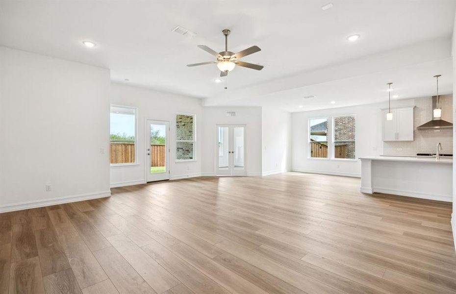 Spacious living room with view of kitchen